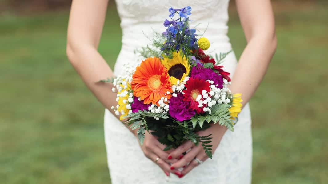 colourful wedding bouquet with sunflowers and yellow and orange colour rainbow colour scheme