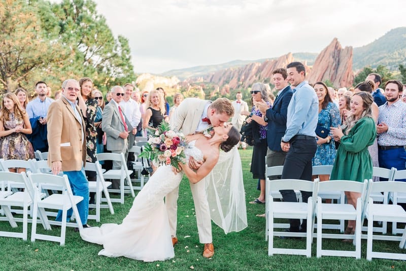 bride and groom kiss at wedding on a golf course
