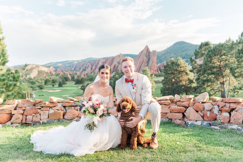 bride and groom with dog at a golf course
