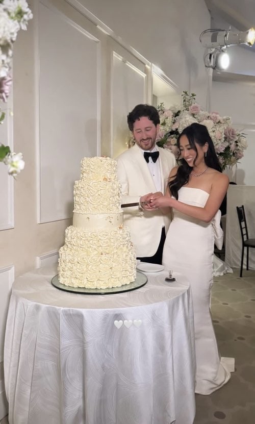 Christina and Ron cut their beautiful rose-adorned cake