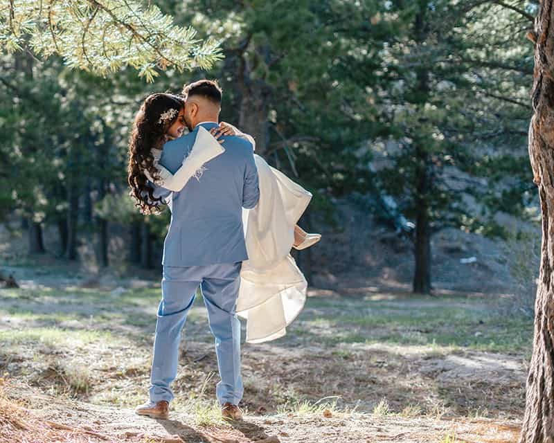 groom picking up bride at Mount Charleston wedding styled shoot