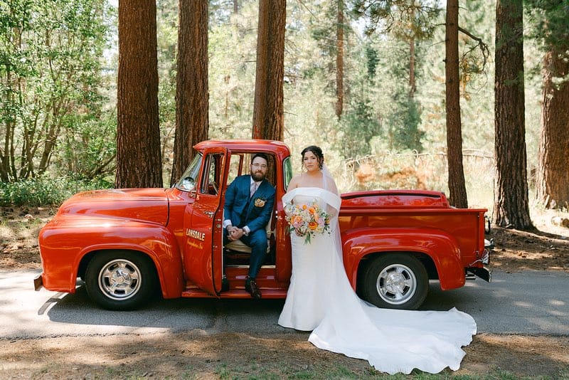 groom and bride inside a red car at their Lakeside Wedding at Valhalla Tahoe 