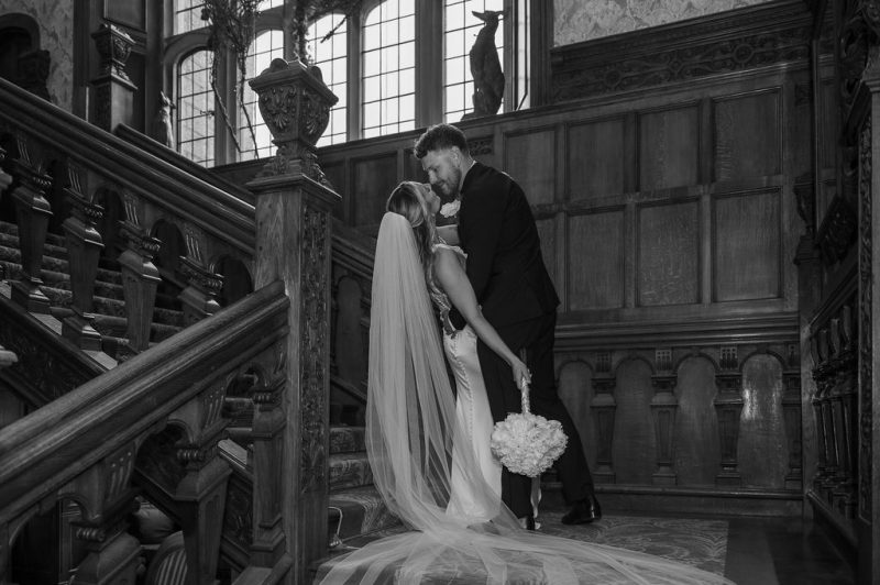 Lucy & Lewis's Romantic Bovey Castle Elopement (Plus Tips For Planning Your Own!) groom kissing bride at stairs of castle