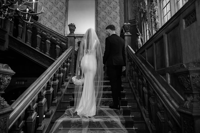 Lucy & Lewis's Romantic Bovey Castle Elopement (Plus Tips For Planning Your Own!) bride and groom going up the stairs at castle elopement