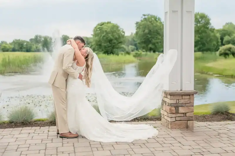 groom kissing bride at Traditions at the Links wedding venue in syracuse