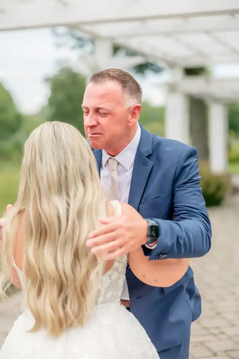 groom kissing bride at Traditions at the Links wedding venue in syracuse