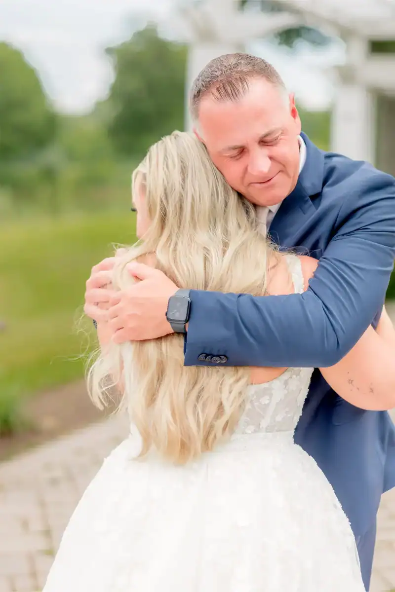 father of the bride hugs her