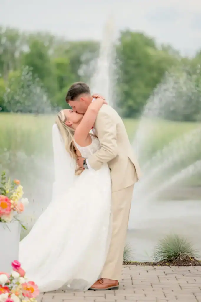 the groom kisses the bride at syracuse wedding venue